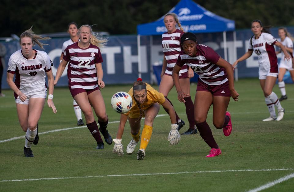 South Carolina goalKeeper Heather Hinz (No. 1) tries to collect a loose ball in the box while Texas A&M Striker Jazmine Wilkinson (No. 21) battles for possession during the SEC Soccer Tournament quarterfinals in Pensacola, FL. on Tuesday, Oct. 31, 2023.