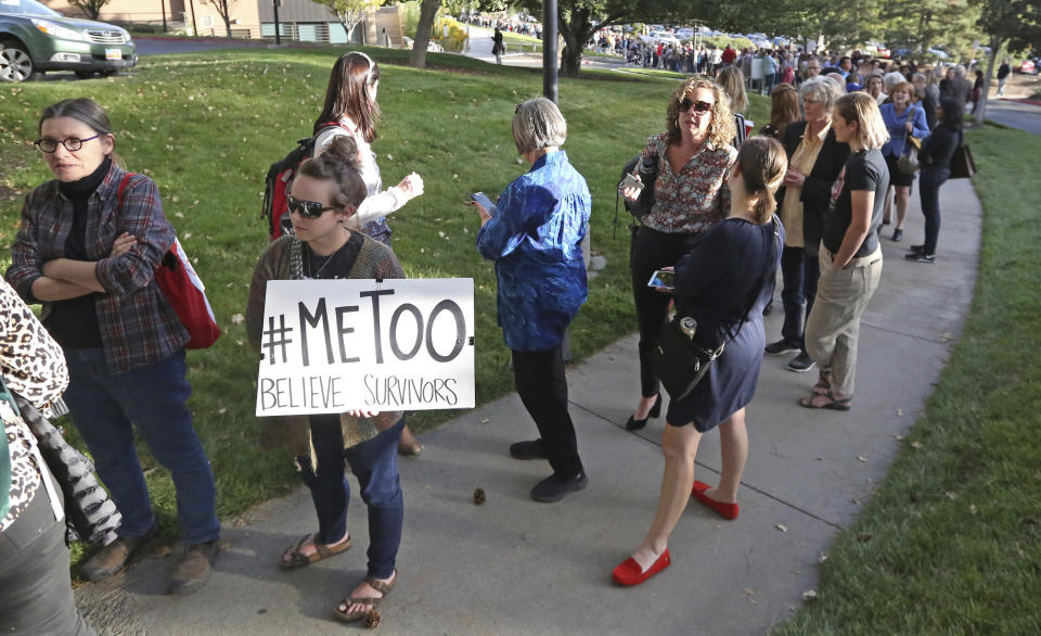 People wait in line to hear Anita Hill speak at the University of Utah, Wednesday, Sept. 26, 2018, in Salt Lake City. Hill has been back in the spotlight since Christine Blasey Ford accused Supreme Court nominee Brett Kavanaugh of sexually assaulting her when the two were in high school. Hill's 1991 testimony against Clarence Thomas riveted the nation. Thomas was confirmed anyway, but the hearing ushered in a new awareness of sexual harassment. (AP Photo/Rick Bowmer)