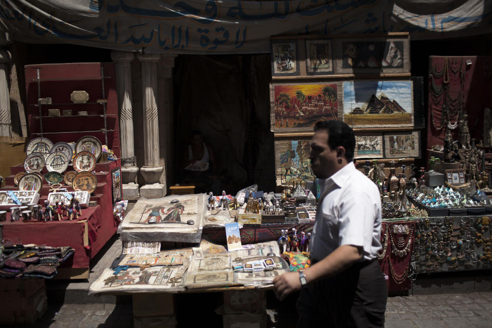 An Egyptian man walks in front of a souvenir store in the Khan El-Khalili market, normally a popular tourist destination, in Cairo, Egypt, Wednesday, Aug. 21, 2013. Riots and killings that erupted across the country after the crackdown against followers of ousted President Mohammed Morsi have delivered a severe blow to Egypt's tourism industry, which until recently accounted for more than 11 percent of the country's gross domestic product and nearly 20 percent of its foreign currency revenues. (AP Photo/Manu Brabo)