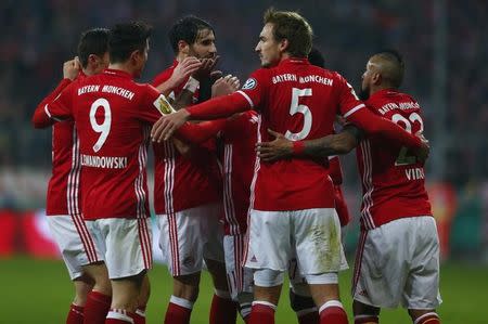 Football Soccer - Bayern Munich v VFL Wolfsburg - German Cup (DFB Pokal) - Allianz Arena Munich, Germany - 7/2/17 - Bayern Munich players celebrate a goal of Douglas Costa (Covered) against VFL Wolfsburg. REUTERS/Michaela Rehle/Files