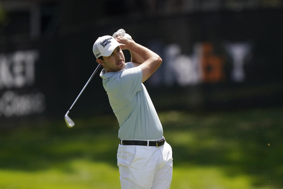 Patrick Cantlay watches his approach shot onto the seventh green during the final round of the Rocket Mortgage Classic golf tournament, Sunday, July 31, 2022, in Detroit. (AP Photo/Carlos Osorio)