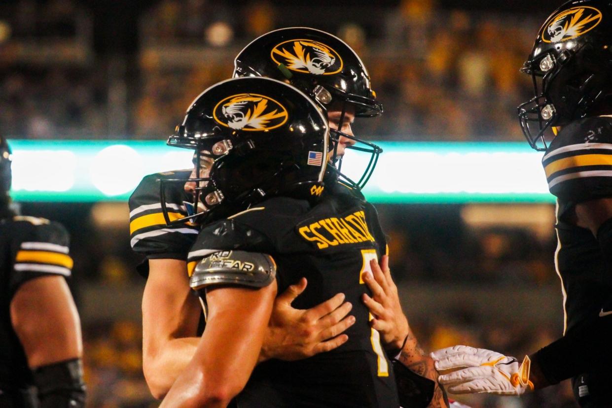 Missouri quarterback Brady Cook hugs running back Cody Schrader during the Tigers' 35-10 win over South Dakota at Memorial Stadium on August 31, 2023, in Columbia, Mo.