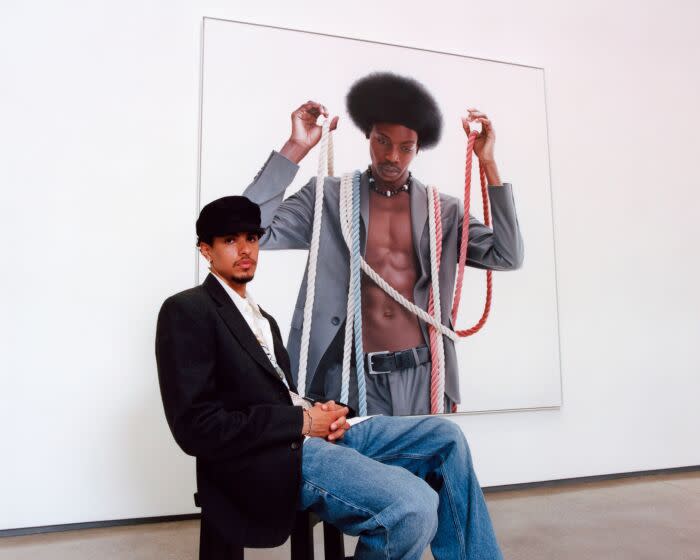 Artist Delfin Finley with his new paintings at the David Kordansky Gallery where his solo exhibition opens May 12, 2023. (Gabriel S. Lopez / For The Times)