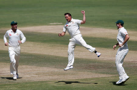 Cricket - India v Australia - First Test cricket match - Maharashtra Cricket Association Stadium, Pune, India - 25/02/17. Australia's Steve O'Keefe (C) celebrates with team mates the wicket of India's captain Virat Kohli. REUTERS/Danish Siddiqui