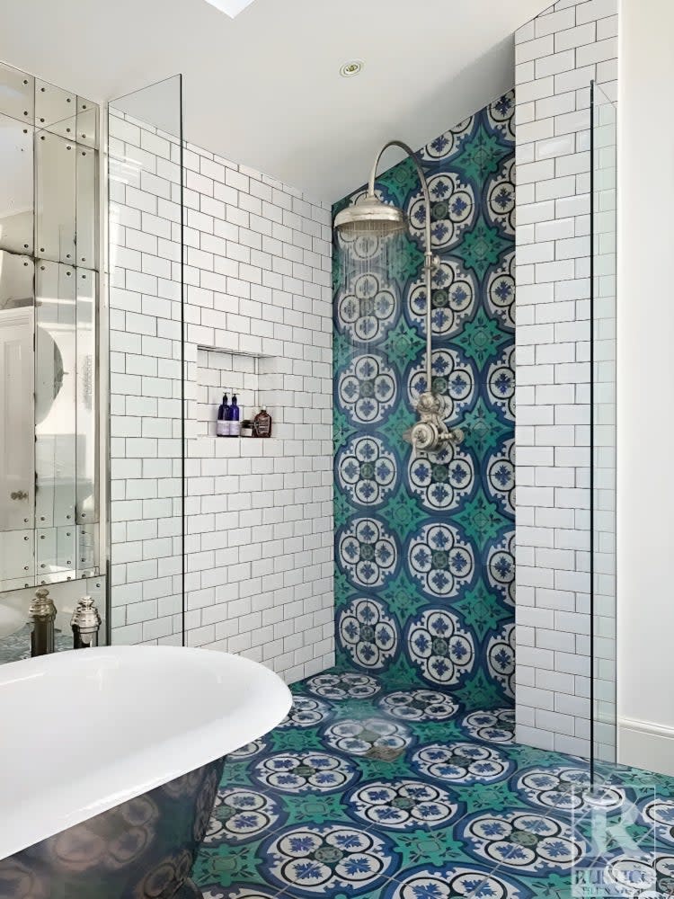 Doorless shower with white subway and blue encaustic shower tile