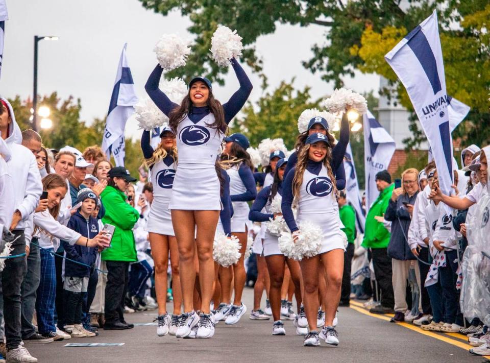 The Penn State cheerleaders pump up the crowd for the football team to arrive at Beaver Stadium on Saturday, Sept. 23, 2023.