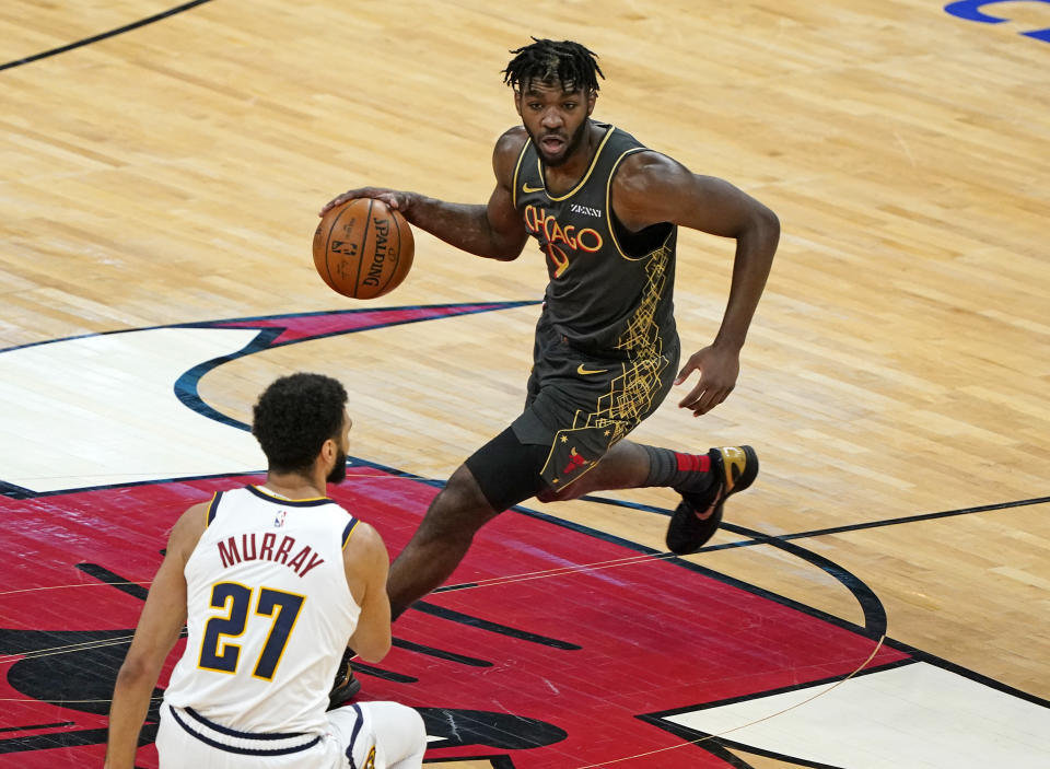 Mar 1, 2021; Chicago, Illinois, USA; Chicago Bulls forward Patrick Williams (9) dribbles the ball against Denver Nuggets guard Jamal Murray (27) during the second quarter at the United Center. 