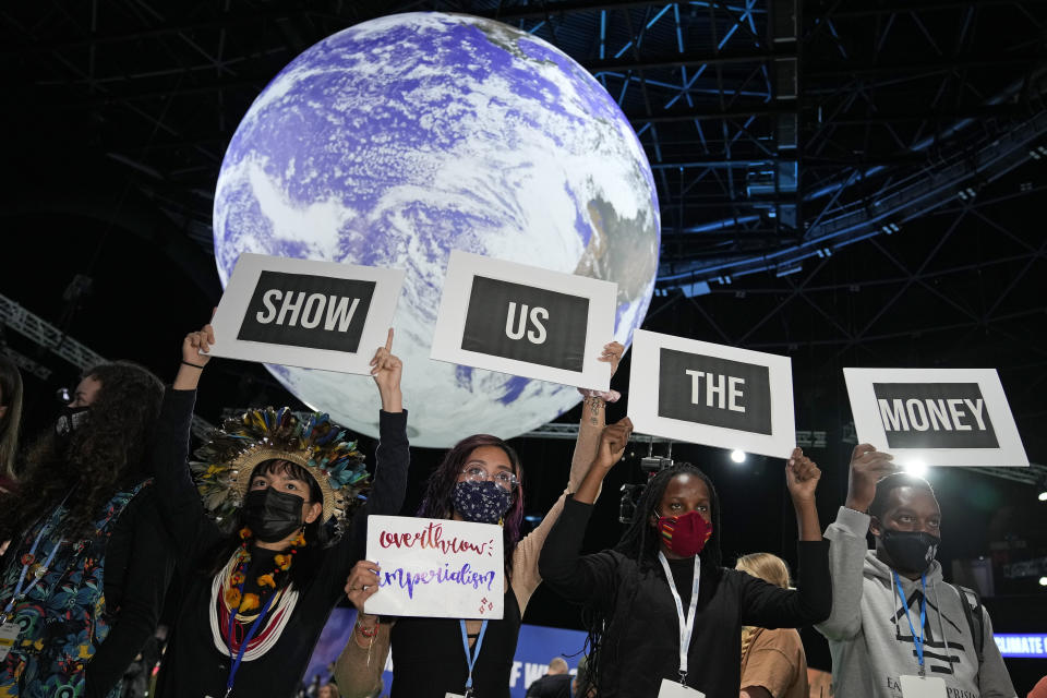 Climate activist Vanessa Nakate, second right, and other activists engage in a 'Show US The Money' protest at the COP26 U.N. Climate Summit in Glasgow, Scotland, Monday, Nov. 8, 2021. The U.N. climate summit in Glasgow gathers leaders from around the world, in Scotland's biggest city, to lay out their vision for addressing the common challenge of global warming. (AP Photo/Alastair Grant)