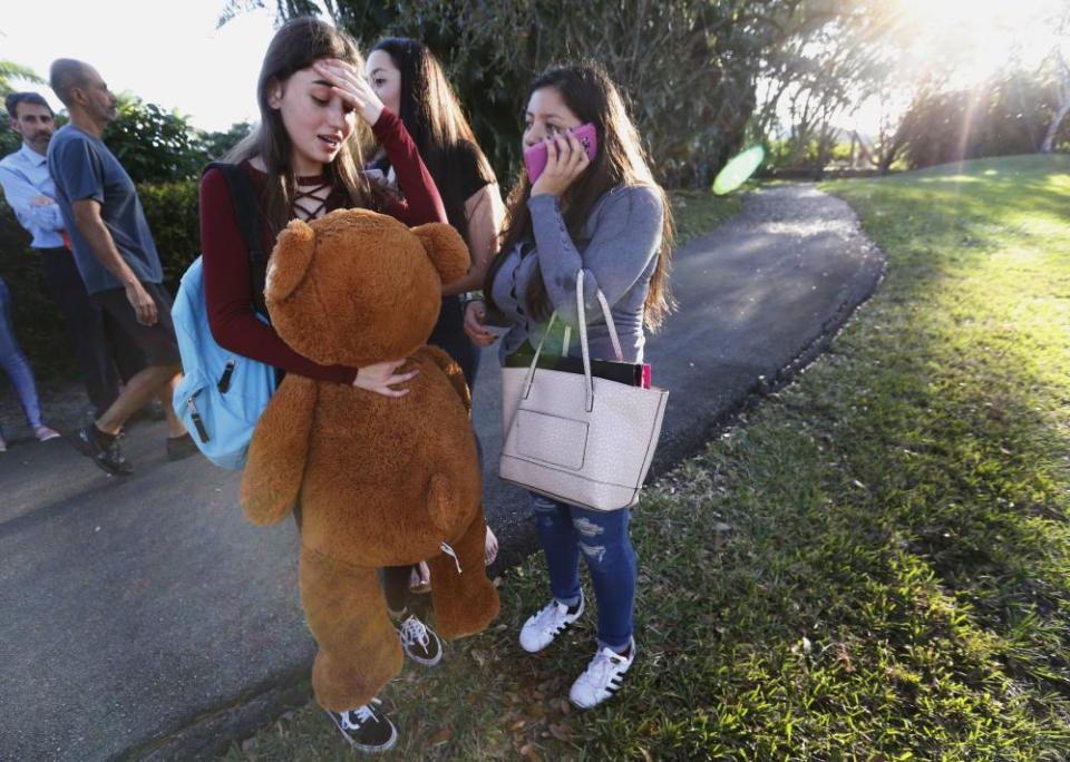 Students wait to be picked up after the shooting.