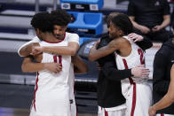 Alabama players hug after losing to UCLA 88-86 in overtime in a Sweet 16 game in the NCAA men's college basketball tournament at Hinkle Fieldhouse in Indianapolis, Sunday, March 28, 2021. (AP Photo/Michael Conroy)
