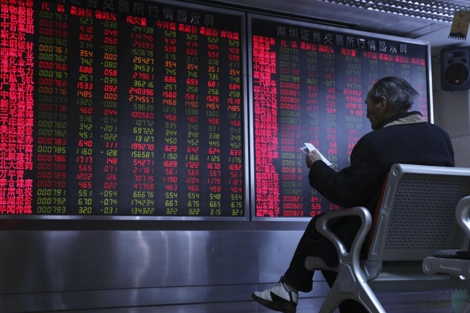 A Chinese man monitors stock prices at a brokerage in Beijing, China, Thursday, Feb. 21, 2019. Asian stock markets were little-changed Thursday following a listless day on Wall Street ahead of U.S.-Chinese negotiations aimed at ending a tariff battle. (AP Photo/Ng Han Guan)