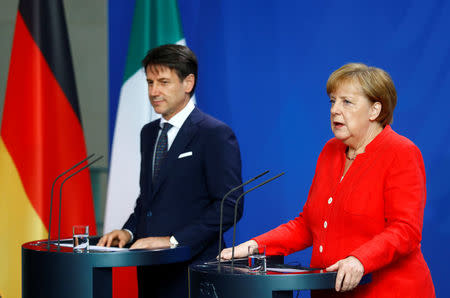 German Chancellor Angela Merkel and Italian Prime Minister Giuseppe Conte hold a news conference at the chancellery in Berlin, Germany, June 18, 2018. REUTERS/Hannibal Hanschke