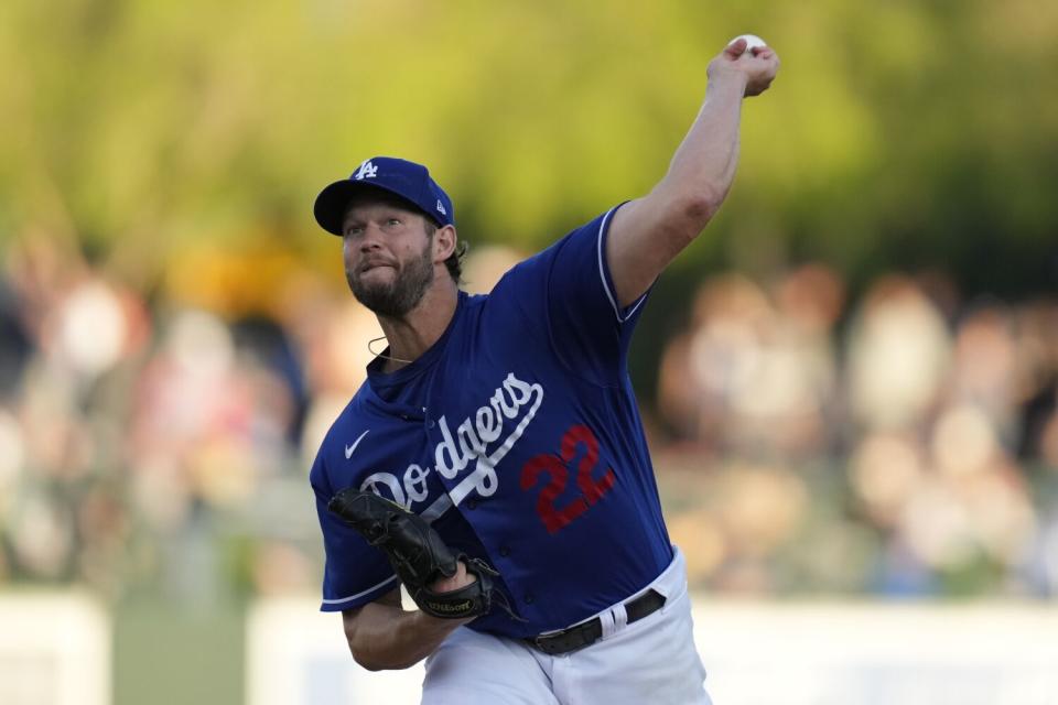 Clayton Kershaw (22) throws during the first inning of a spring training baseball game