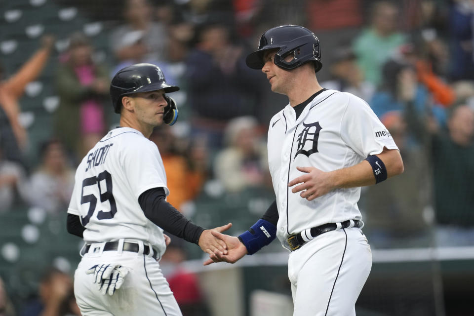 Detroit Tigers' Zack Short (59) and Carson Kelly, right, celebrate scoring against the Kansas City Royals in the seventh inning of a baseball game, Thursday, Sept. 28, 2023, in Detroit. (AP Photo/Paul Sancya)
