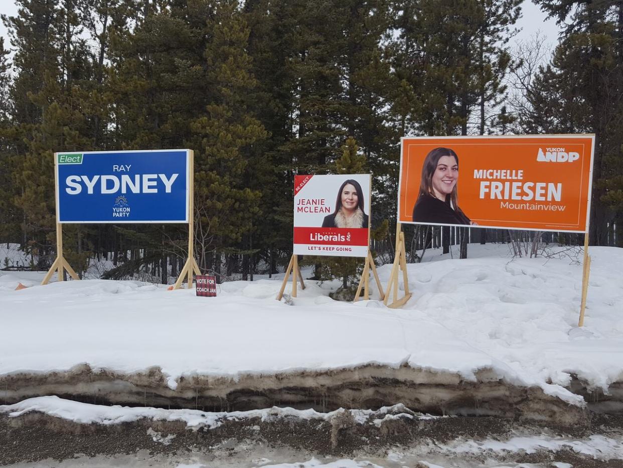 Election signs for the 2021 territorial election in Yukon. In a report, the Electoral Boundaries Commission recommended the the territory add more ridings to Whitehorse, while merging some ridings outside of the capital.  (Mark Evans/CBC - image credit)