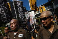 Demonstrators, wearing prison uniforms, march in protest of the jailing of student leaders Joshua Wong, Nathan Law and Alex Chow, who were imprisoned for their participation of the 2014 pro-democracy Umbrella Movement, also known as "Occupy Central" protests, in Hong Kong China August 20, 2017. REUTERS/Tyrone Siu