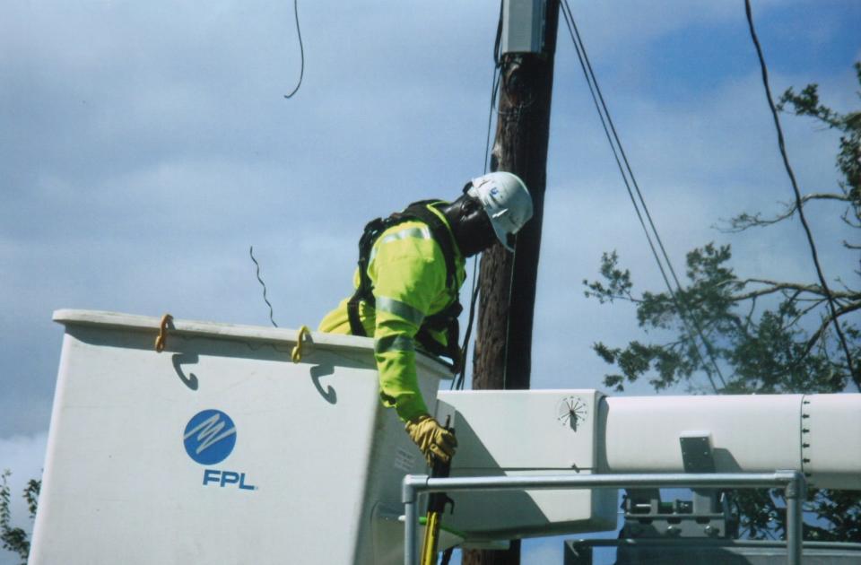 An FPL lineman works on restoring power in Holly Hill in this file photo.