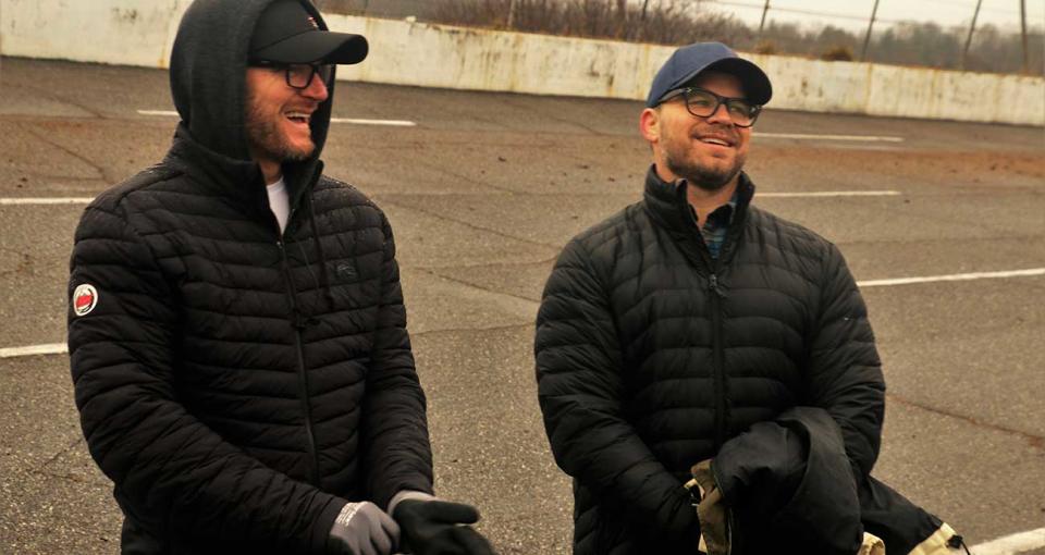 Dale Earnhardt Jr., left, and Marcus Smith in clean-up efforts at North Wilkesboro Speedway