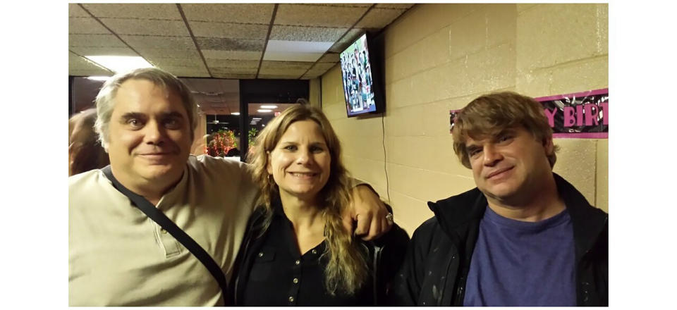 This October 2015 photo provided by John Michels, left, shows his brother Paul Andre Michels, right, posing with his sister Sarah Michels and himself, in Allen Park, Michigan. Paul Michels was among eight people killed March 16, 2021, in shootings at three Georgia massage parlors in the Atlanta area. (John Michels via AP)