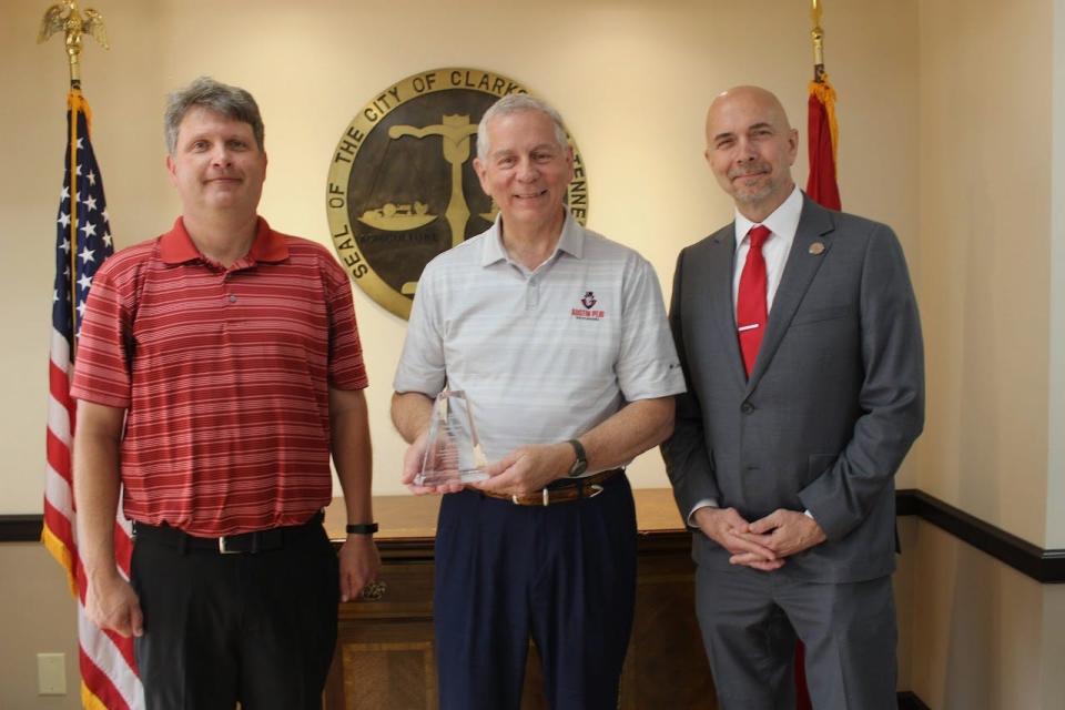 Dr. William "Buzz" Hoon, dean of APSU's College of Arts and Letters (at right), presents Clarksville Mayor Joe Pitts (center) with a Distinguished Alumni Award.