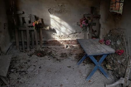 Old crosses are seen inside a chapel at a cemetery in the village of Sapine, Serbia, October 25, 2016. REUTERS/Marko Djurica