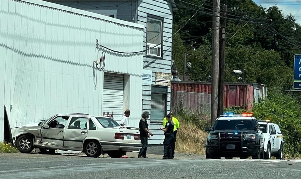 One of the city’s first community service officers (dressed in a fluorescent-yellow shirt) responds to a car accident in Tacoma on Monday, July 1, 2024.