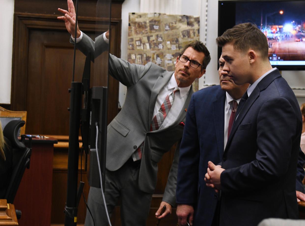 Thomas Binger, Mark Richards and Kyle Rittenhouse look at a monitor during the trial.