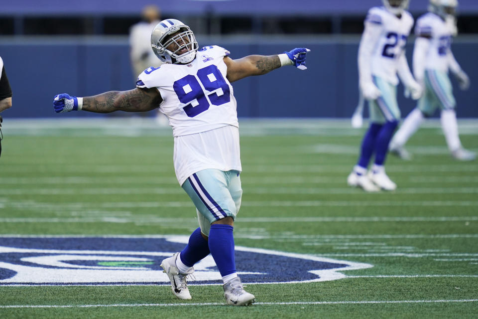 Dallas Cowboys defensive tackle Antwaun Woods (99) celebrates after he sacked Seattle Seahawks quarterback Russell Wilson during the second half of an NFL football game, Sunday, Sept. 27, 2020, in Seattle. (AP Photo/Elaine Thompson)