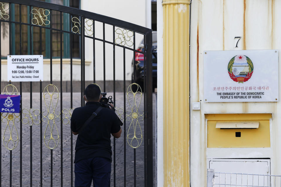 A journalist films outside the North Korean Embassy in Kuala Lumpur, Malaysia, Saturday, March 20, 2021. Malaysia said Friday it will order all North Korean diplomats to leave the country within 48 hours, an escalation of diplomat brawl over Malaysia's move to extradite a North Korean suspect to the United States for money laundering charges. (AP Photo/Lai Seng Sin)