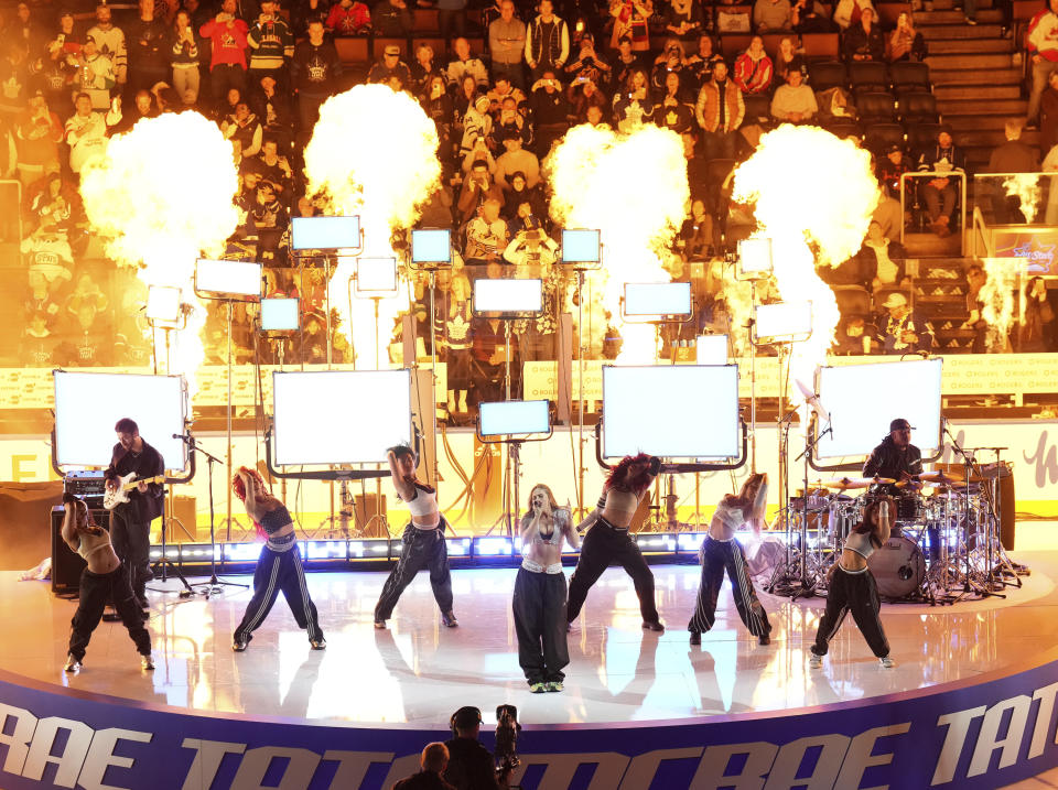 Singer Tate McRae, center, performs during an intermission at hockey's NHL All-Star Game in Toronto, Saturday, Feb. 3, 2024. (Nathan Denette/The Canadian Press via AP)