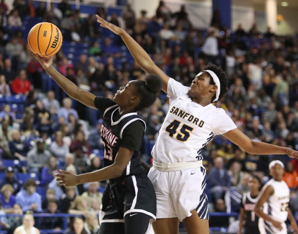 Ursuline's Jezelle Banks (left) drives as Sanford's Naomi Allen pursues in the first half of the DIAA state tournament championship game at the Bob Carpenter Center, Friday, March 10, 2023.