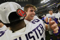 Kansas State quarterback Will Howard, center, celebrates with teammate Colby McCalister, left, after Kansas State defeated TCU in the Big 12 Conference championship NCAA college football game, Saturday, Dec. 3, 2022, in Arlington, Texas. (AP Photo/LM Otero)