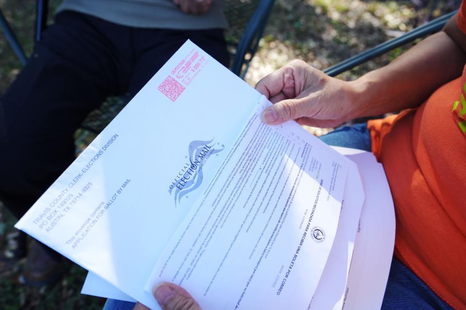 Alice Yi and her 92-year-old father Yilu Zhao discuss how his mail in ballot was rejected several times because of a non-ID match in Alice’s backyard Friday, Oct. 21, 2022, in Austin. Zhao’s application was accepted too late for him to vote by mail for primary elections but was able to vote by mail for this election.