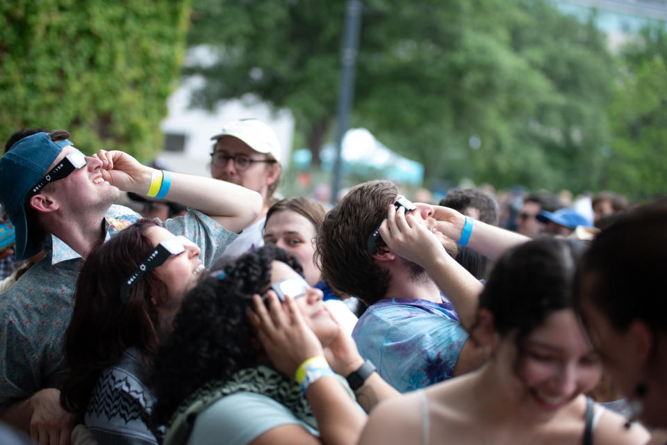 AUSTIN, TEXAS - APRIL 08: People view the solar eclipse during Vampire Weekend's Total Solar Eclipse Show at Moody Amphitheater at Waterloo Park on April 08, 2024 in Austin, Texas. (Photo by Hubert Vestil/Getty Images)