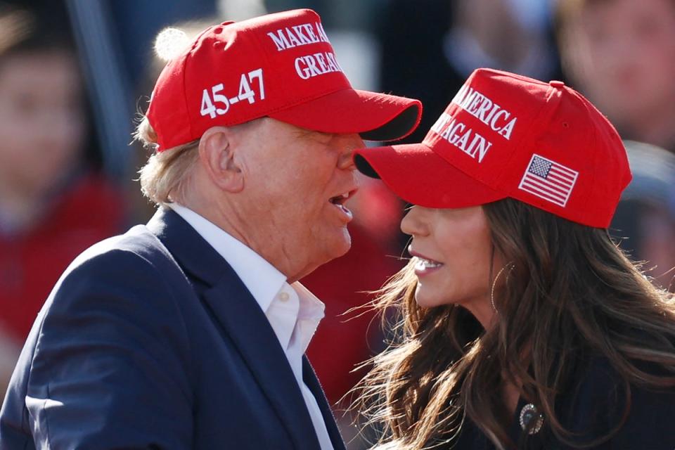 Donald Trump (left) speaks to Kristi Noem (right) at an Ohio campaign rally in March 2024 (AFP via Getty Images)