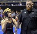 <p> Mack Beggs, left, a transgender wrestler from Euless Trinity High School, stands with his coach Travis Clark during a quarterfinal match against Mya Engert, of Amarillo Tascosa, during the State Wrestling Tournament, Friday, Feb. 24, 2017, in Cypress, Texas. Beggs was born a girl and is transitioning to male but wrestles in the girls division. ( Melissa Phillip/Houston Chronicle via AP) </p>