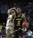 Wichita State's Jamarius Burton (2) brings the ball up court past Temple's Nate Pierre-Louis (15) during the first half of an NCAA college basketball game Wednesday, Jan. 15, 2020, in Philadelphia. (AP Photo/Michael Perez)