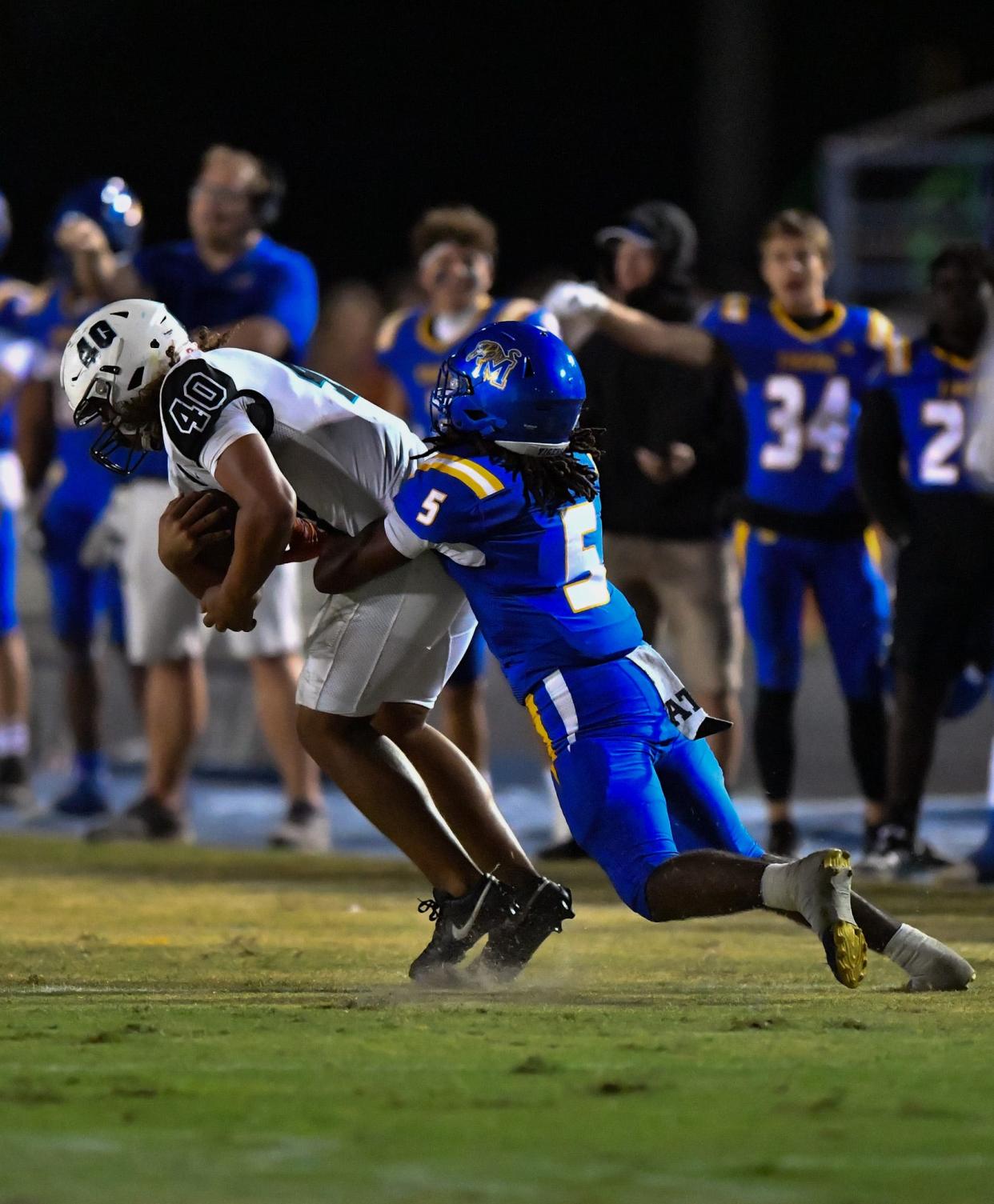 Jensen Beach linebacker Julius Puryear (40) intercepts a pass in a high school football game against Martin County, Thursday, Nov. 2, 2023.