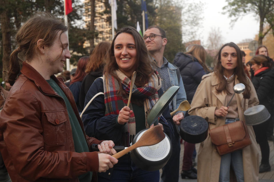 People bang pots and pans while French President Emmanuel Macron seeks to diffuse tensions in a televised address to the nation, Monday, April 17, 2023 in Lille, northern France. French President Emmanuel Macron, who just enacted protest-igniting pension changes, is expected to provide details about his domestic policies in the coming months. (AP Photo/Michel Spingler)