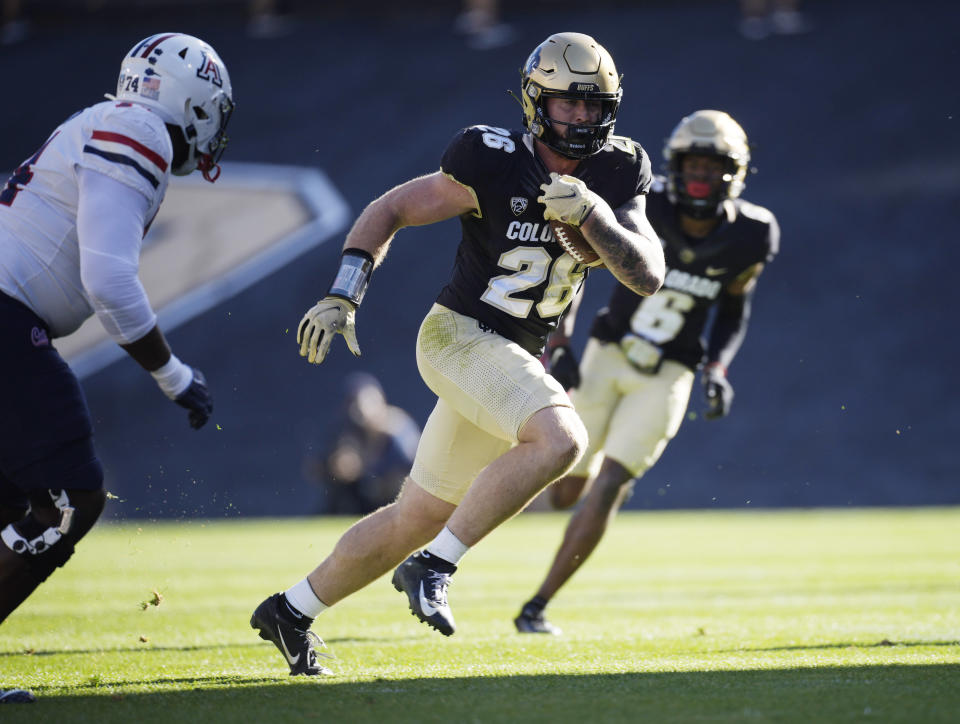 Colorado cornerback Tyrin Taylor, front right, runs for a touchdown after picking off a pass as Arizona wide receiver Dorian Singer, left, pursues in the second half of an NCAA college football game Saturday, Oct. 16, 2021, in Boulder, Colo. (AP Photo/David Zalubowski)