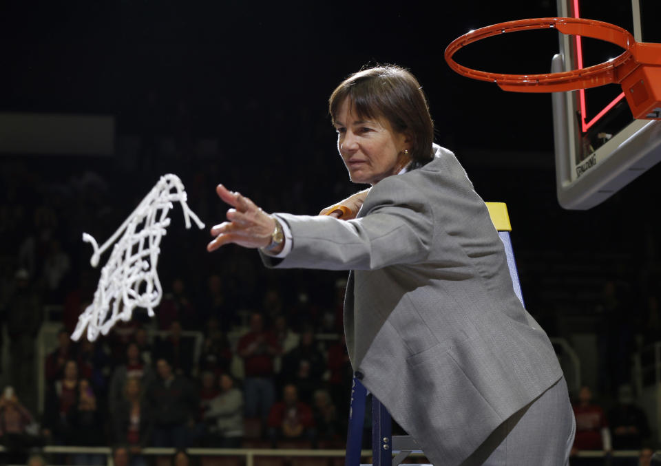 Stanford coach Tara VanDerveer tosses the net to her team after Stanford's 74-65 win over North Carolina in a regional final at the NCAA women's college basketball tournament in Stanford, Calif., Tuesday, April 1, 2014. (AP Photo/Marcio Jose Sanchez)