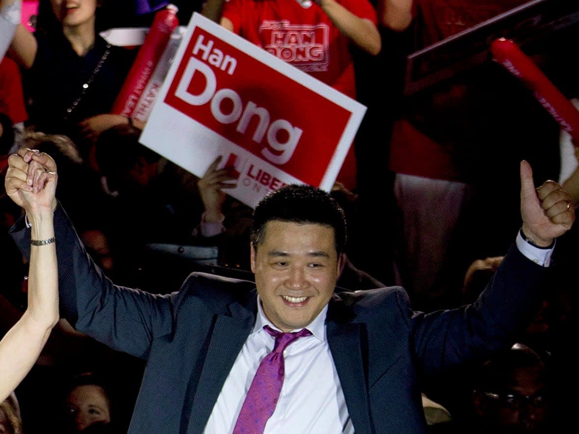 Han Dong celebrates with supporters while taking part in a rally in Toronto on May 22, 2014. The Toronto-area member of Parliament is denying allegations that he worked against the release of Michael Kovrig and Michael Spavor from China. (Nathan Denette/The Canadian Press - image credit)