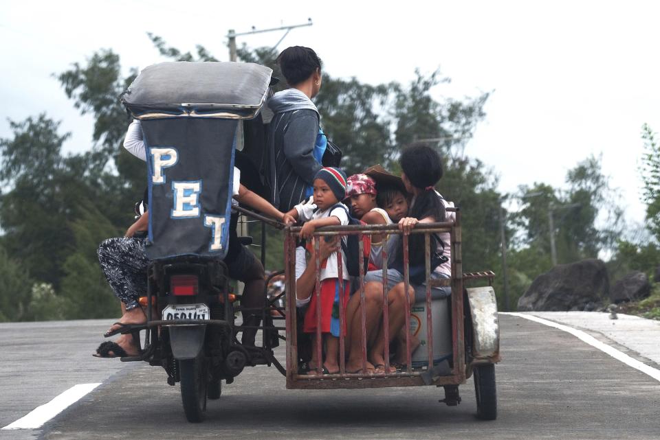 Residents ride a pedicab as they evacuate to higher grounds in preparation for the coming of Typhoon Kammuri in Legazpi, Albay province, southeast of Manila, Philippines on Monday Dec. 2, 2109. The Philippines' main island, including the national capital, Manila, is under a tropical cyclone warning for a typhoon forecast to hit Monday night into Tuesday. (AP Photo)