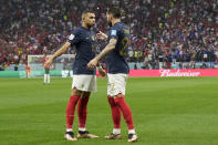 France's Theo Hernandez, right, celebrates with Kylian Mbappe after scoring the opening goal during the World Cup semifinal soccer match between France and Morocco at the Al Bayt Stadium in Al Khor, Qatar, Wednesday, Dec. 14, 2022. (AP Photo/Christophe Ena)
