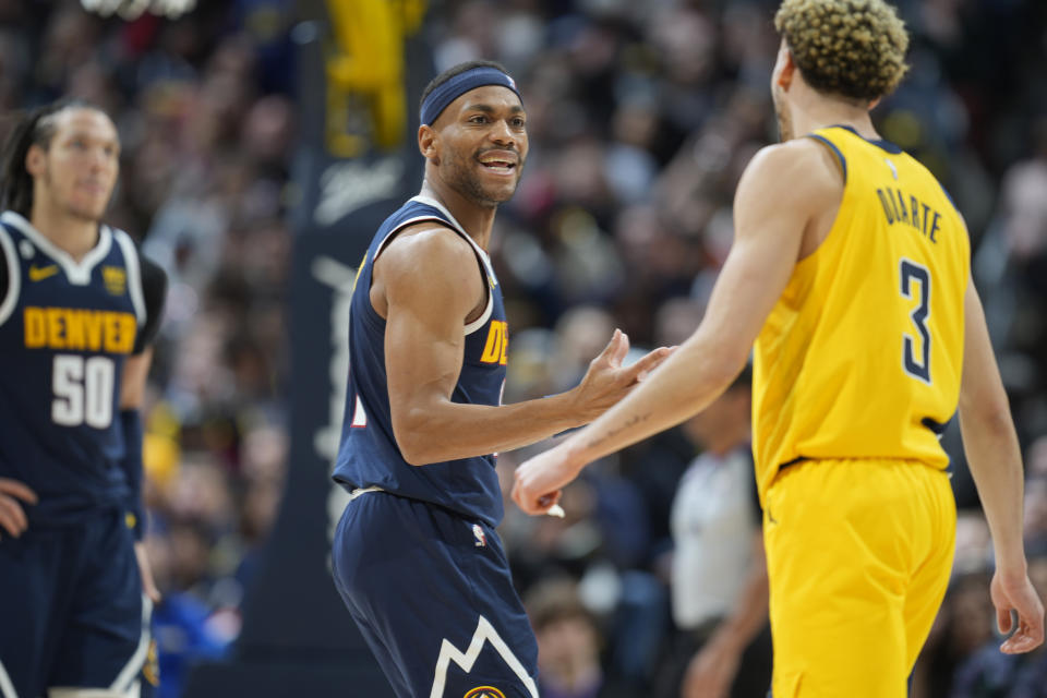 Denver Nuggets forward Bruce Brown, left, reacts after he was called for a foul, next to Indiana Pacers guard Chris Duarte during the second half of an NBA basketball game Friday, Jan. 20, 2023, in Denver. (AP Photo/David Zalubowski)
