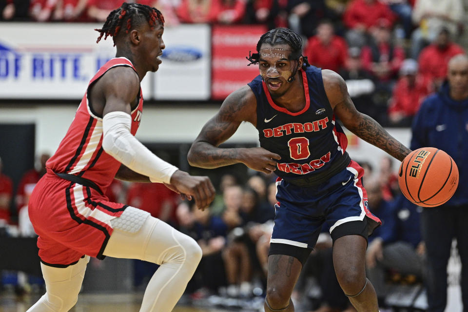 Detroit Mercy guard Antoine Davis drives on Youngstown State guard Dwayne Cohill during the first half of an NCAA college basketball game in the quarterfinals of the Horizon League tournament Thursday, March 2, 2023, in Youngstown, Ohio.(AP Photo/David Dermer)