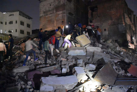 People remove the debris as they search for survivors at the site of a collapsed hotel building in Indore, India, March 31, 2018. Picture taken March 31, 2018. REUTERS/Stringer