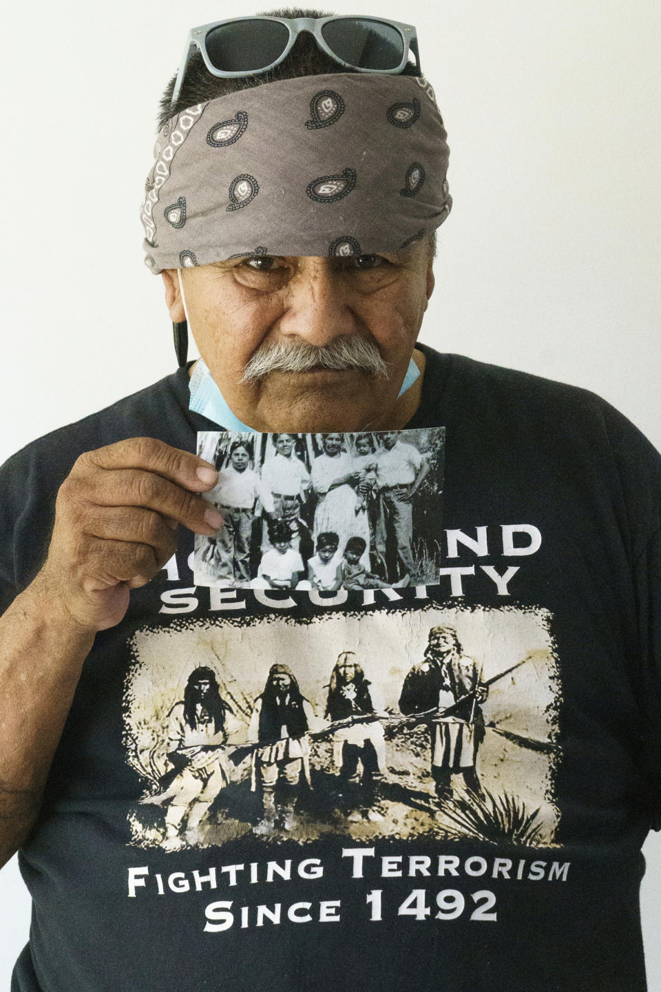 Former Palm Springs Section 14 resident Jerry Salazar, 70, holds a childhood picture of him and his brothers during a meeting at the United Methodist Church in Palm Springs, Calif., Sunday, April 16, 2023. Black and Latino Californians who were displaced from their Section 14 neighborhood in Palm Springs allege the city pushed them out by hiring contractors to destroy homes in an area that was tight-knit and full of diversity. (AP Photo/Damian Dovarganes)