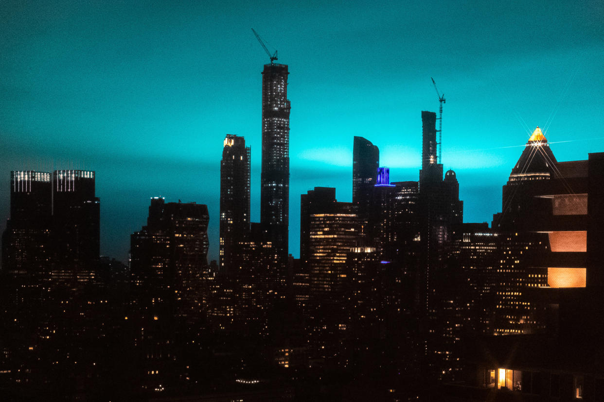 The eerily bright blue glow of a transformer fire in Astoria, Queens illuminated the New York City skyline late Thursday night.