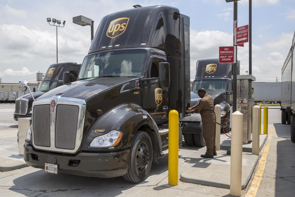 A UPS CNG truck fills up at a fueling station.